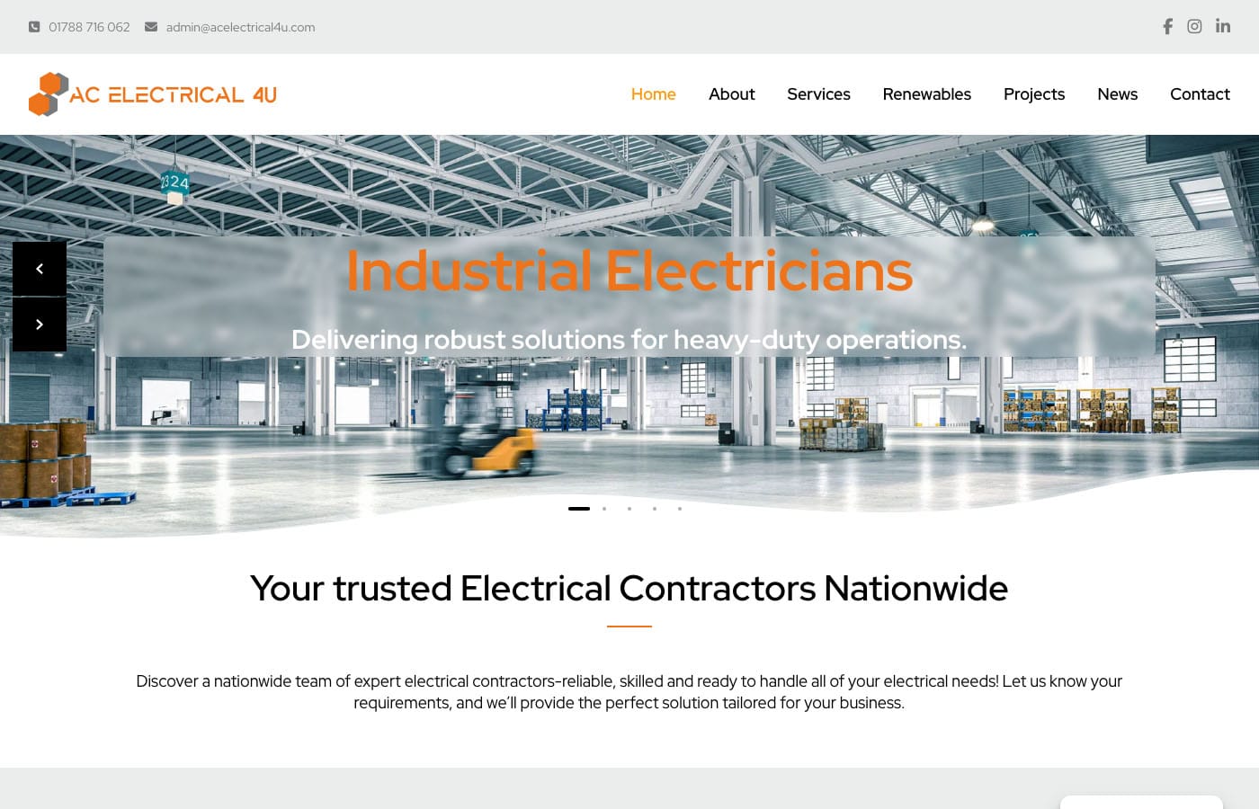 Industrial electricians working in large warehouse facility